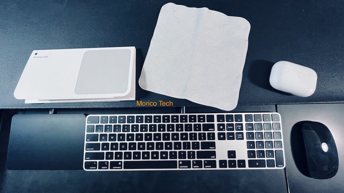 Apple Polishing Cloth on Desktop with Keyboard, trackpad, and mouse, and airpods pro